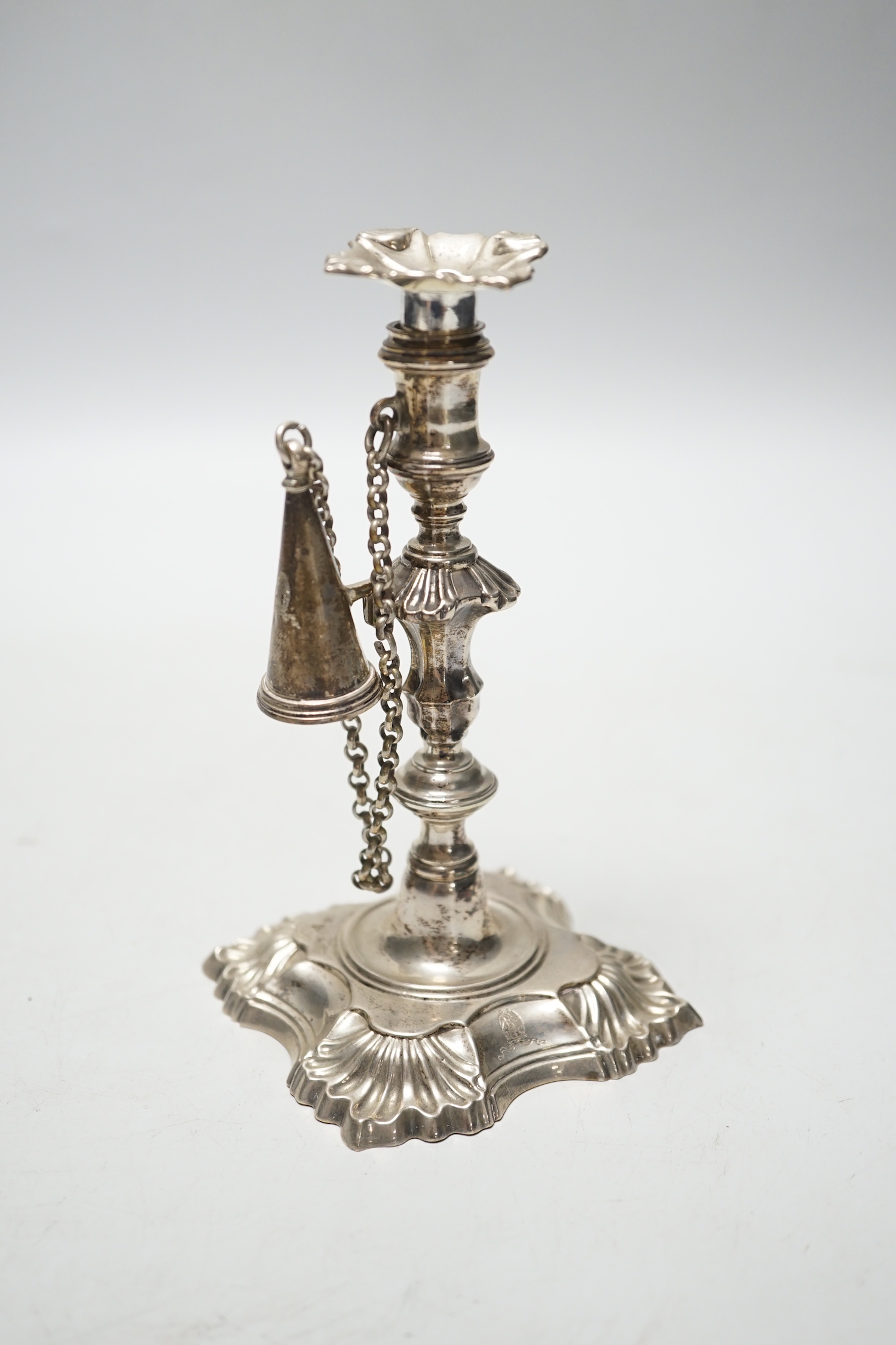 A George II cast silver taper stick, William Gould, London, 1751, with later George IV extinguisher and unmarked sconce, 13.3cm, 6.7oz.